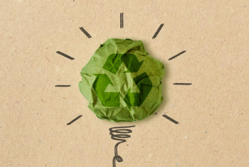 Graphic of a lightbulb drawn on cardboard with green recycling symbol replacing the glass bulb.