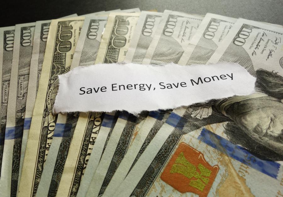 photo of $100 bills spread out and "save energy, save money" written on a piece of paper on top.