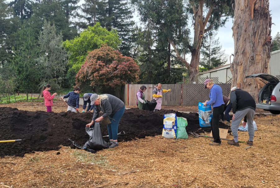 residents scooping free compost into containers to take home