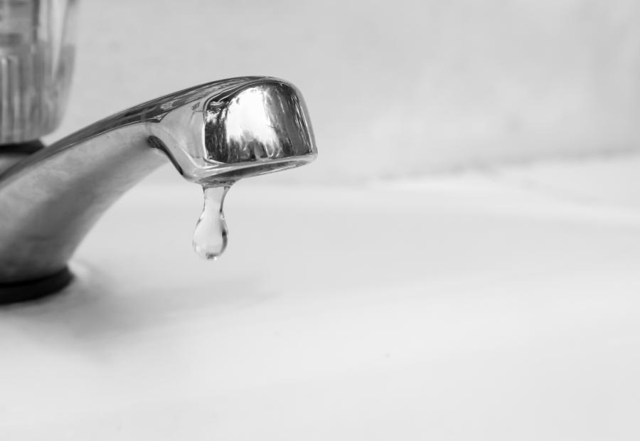 closeup of a faucet dripping