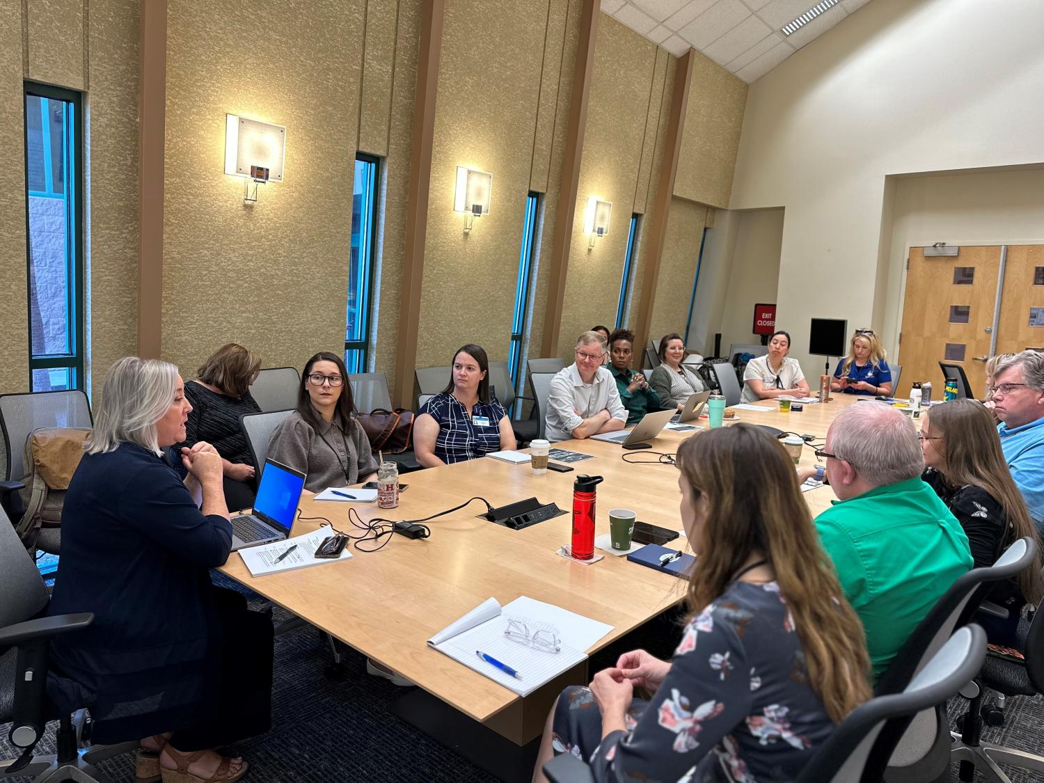 a group of folks sitting around a large conference table