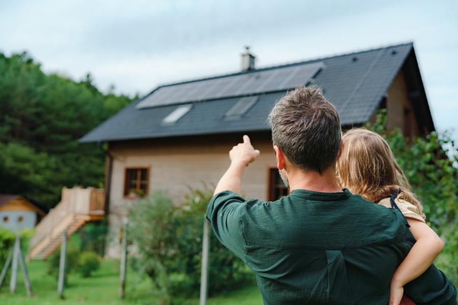 Couple looking at solar panels on roof