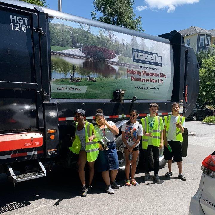 Five young adults pose for a photo with the Casella recycling truck.