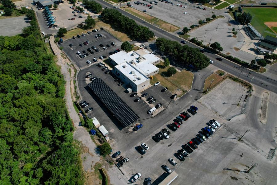 aerial photo of solar panels over parking lot