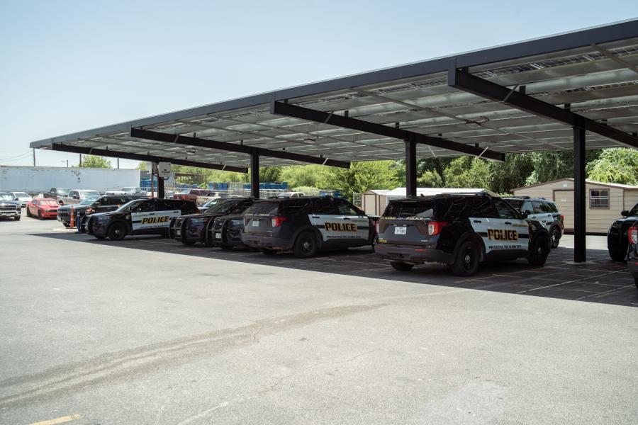 Photo of police vehicles parked under solar panels