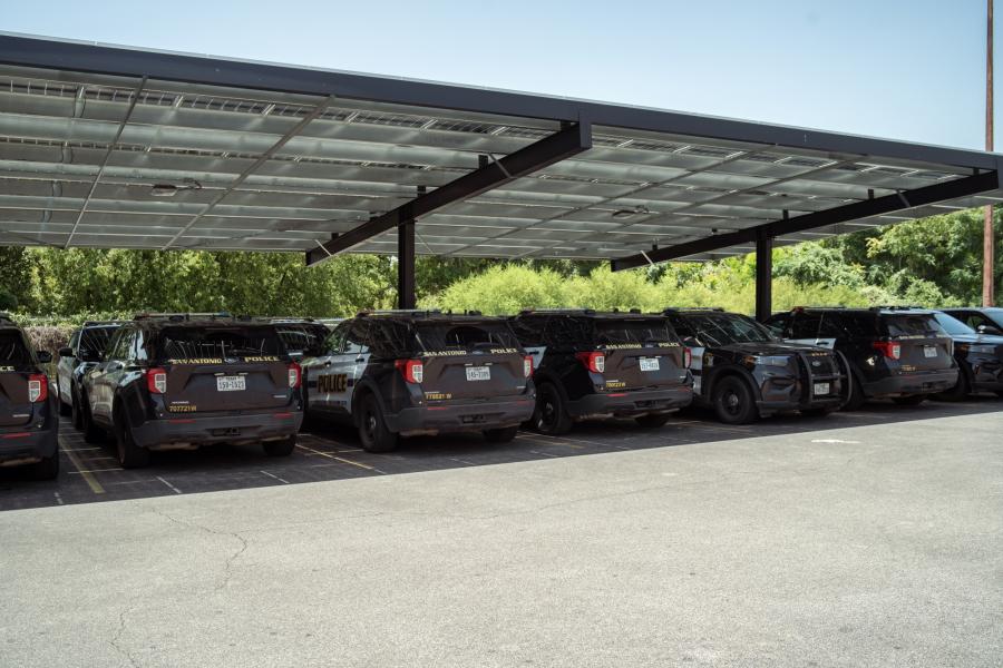 Photo of police vehicles parked under solar panels