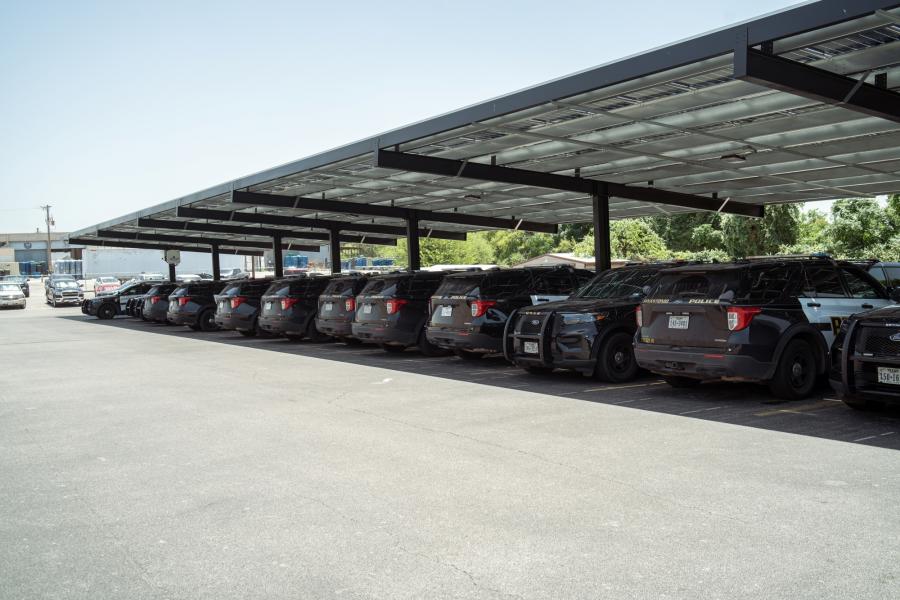 Photo of police vehicles parked under solar panels