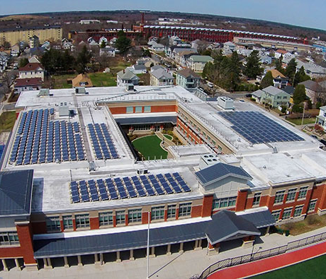 An image of a large building with many solar panels on top of it