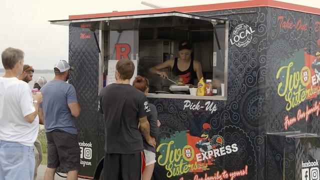 An image of a person working in a busy food truck