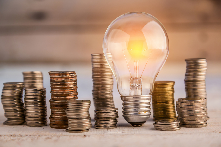 stacked coins around a light bulb