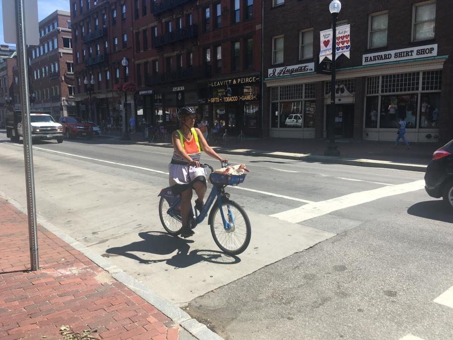 Image of person riding a bike on a city street