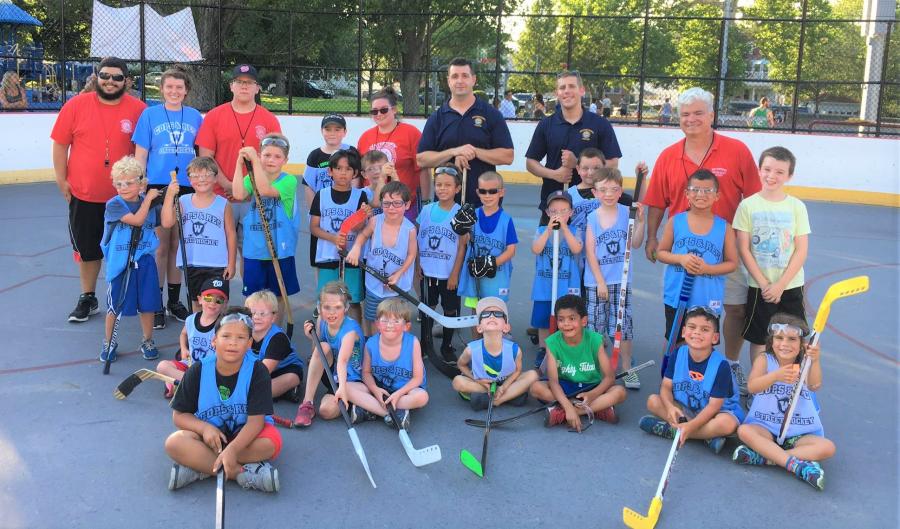 Kids street hockey team with Police Department mentors