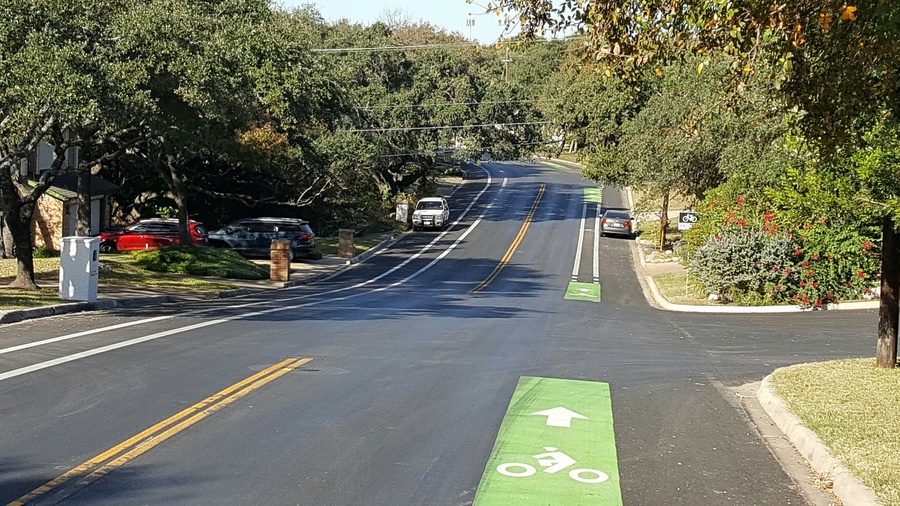 two lane road with a bike lane with green paint